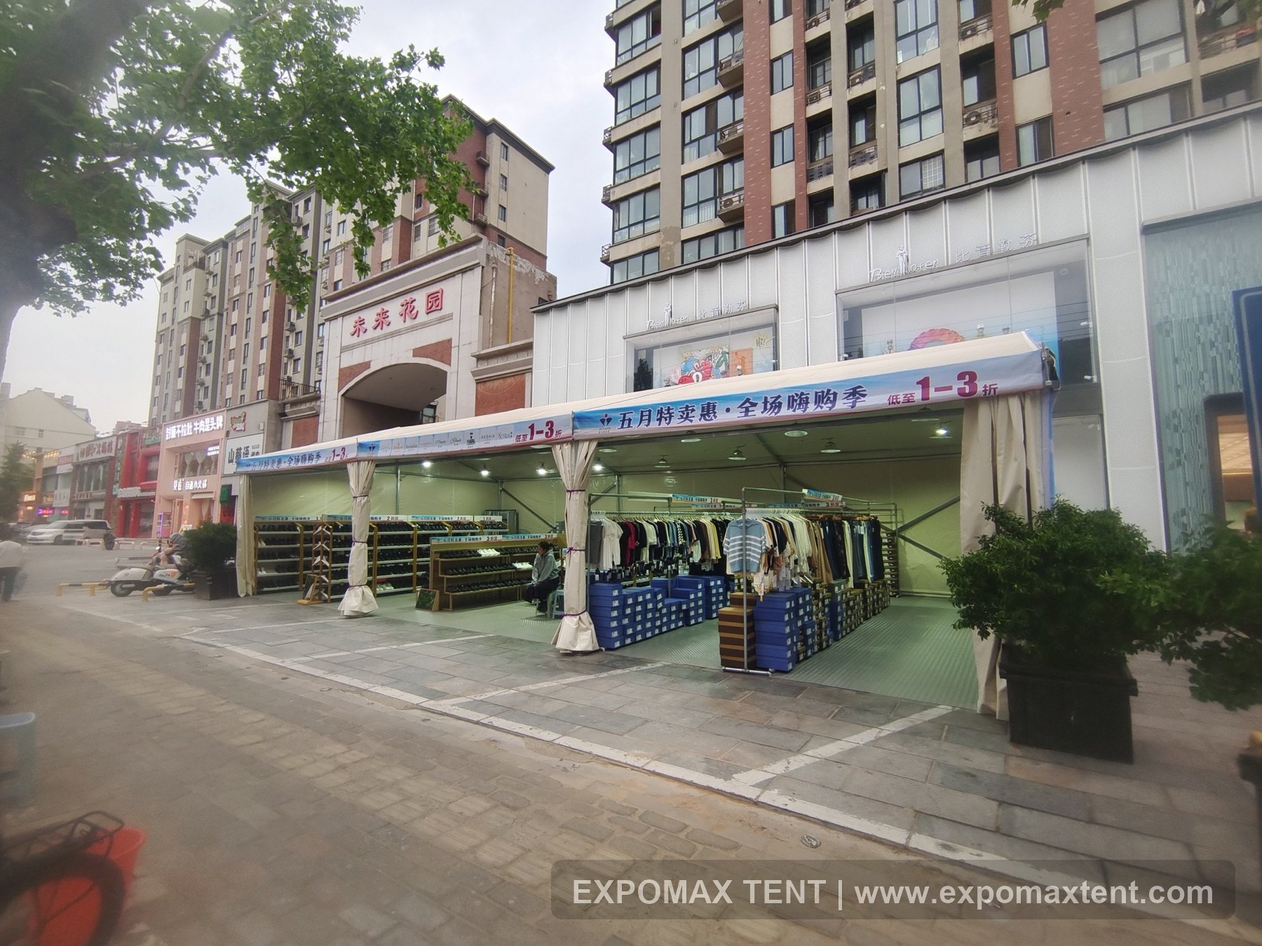 Temporary retail tent in front of a shopping street