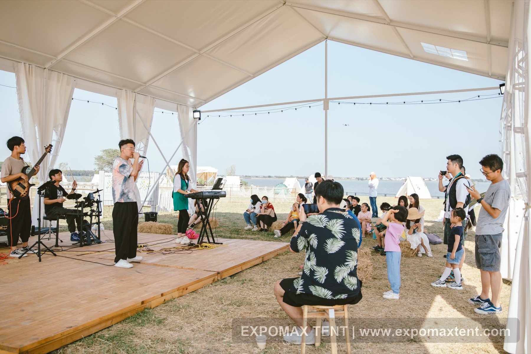 Live performance under white lawn market party tent