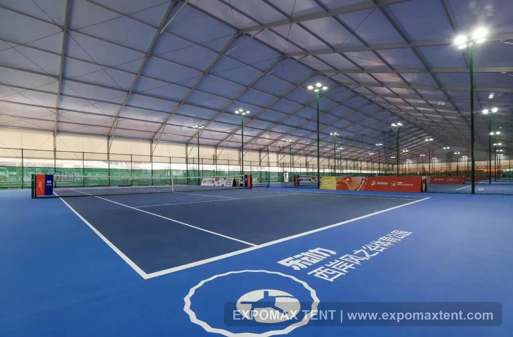 Tennis court inside a large sports tent