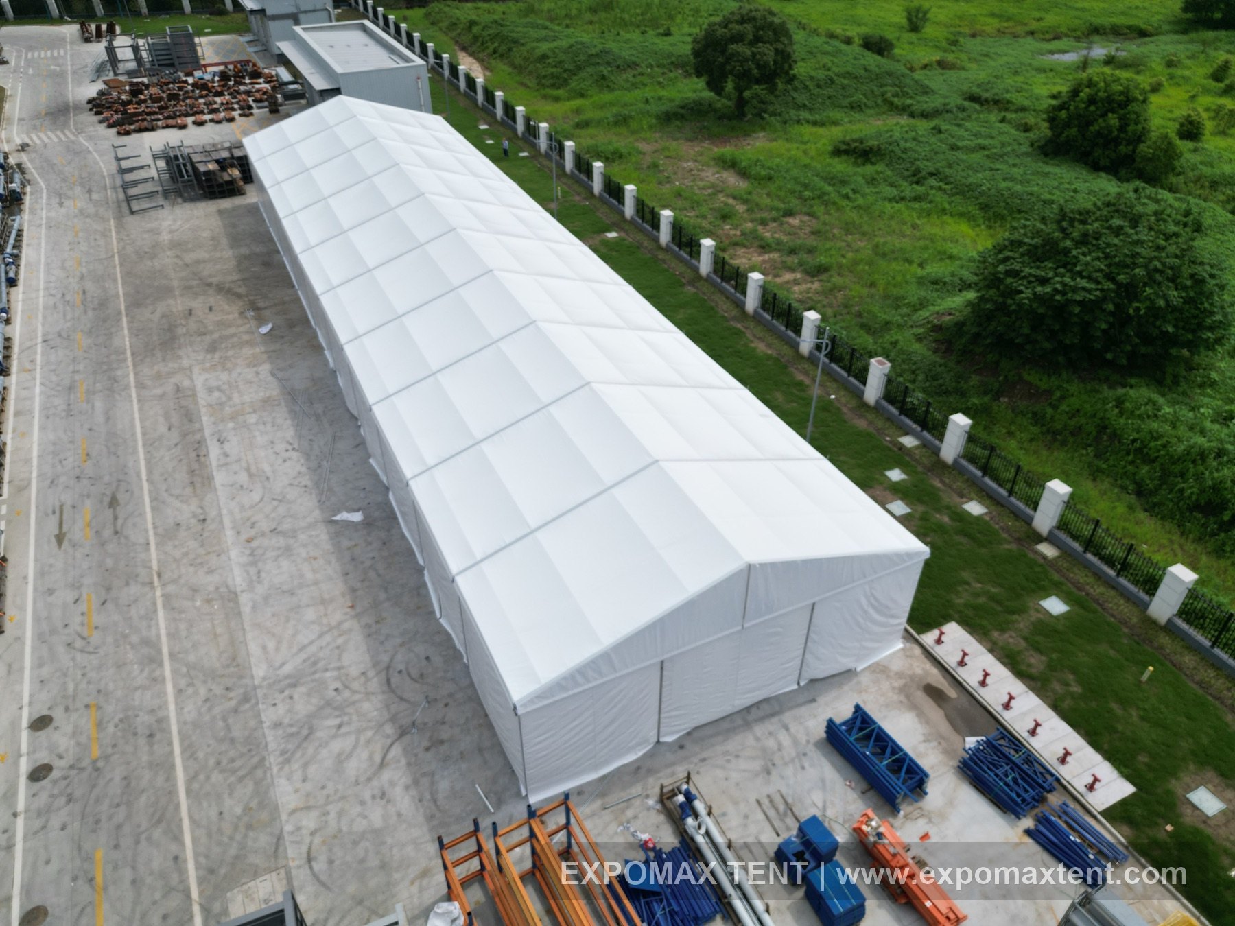 Warehouse tent installed beside an industrial facility